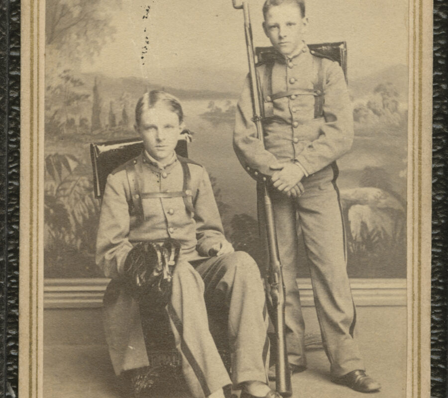 Portraits of two Military Cadets, One Sitting, One Standing both in Uniform